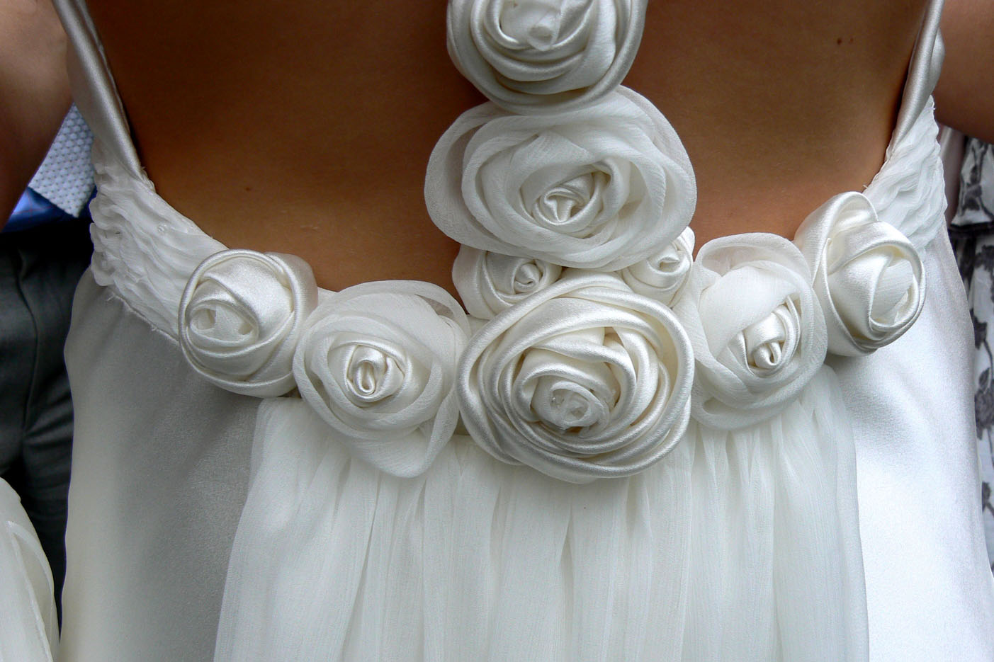 Detail from a bias cut wedding dress trimmed with silk satin and chiffon Dior roses